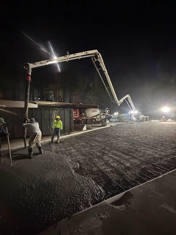 Close-up of concrete being pumped through a boom hose onto a slab form.